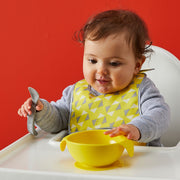 child with silicone first feeding set - lemon sherbet - b.box for kids